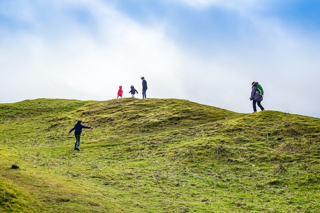 A family hiking on a hilltop.